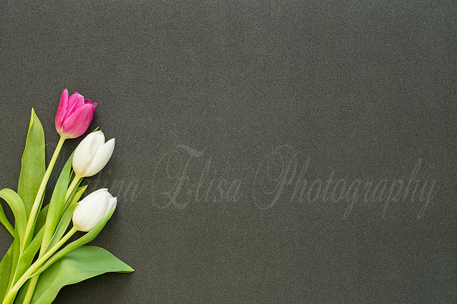 tulips on black glitter desk photo