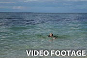 child swims in the tropical sea