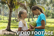 Young girls drinking coconut juice