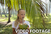 Young girl drinking coconut juice