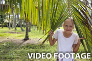Young girl and coconut branch
