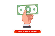 Businessman hand holding dollar bill