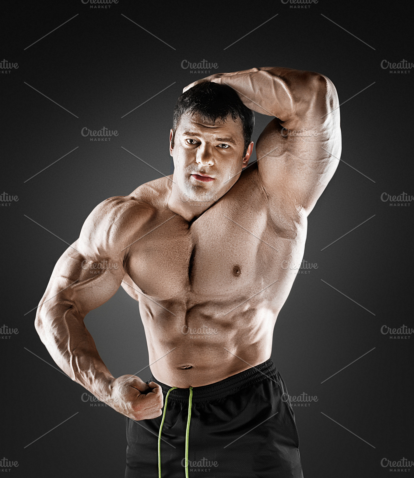 Handsome muscular bodybuilder posing over black background ...