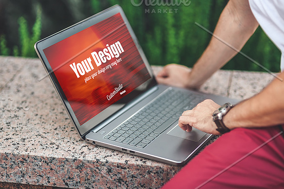 Man uses Laptop PSD Mockup outdoors in Mobile & Web Mockups - product preview 1