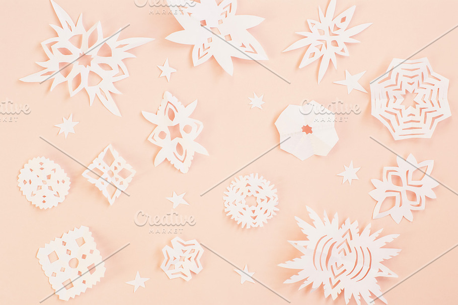 Christmas paper snowflakes on pink