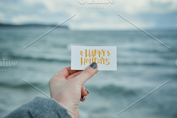 Empty card in girl's Hand on the Sea