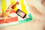 Starfish, sunglasses and phone
