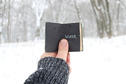 Winter idea. Vintage book with inscription on the background of snow