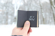Let it snow lettering and Falling snow. Retro book with inscription.
