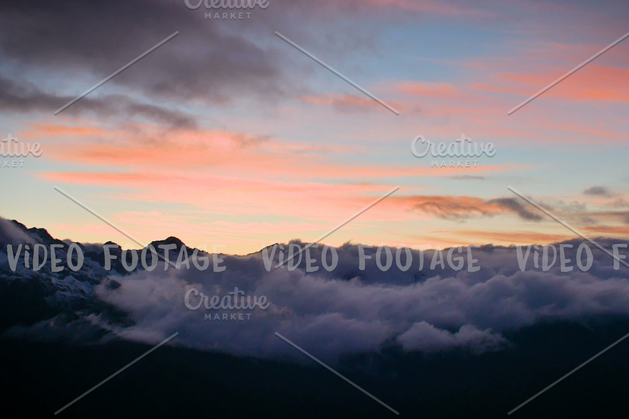 timelapse of winter sunset in high snowy mountains with clouds