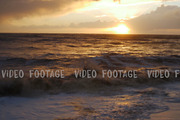 storm in the sea, big waves crashes on the beach in sunset
