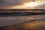 storm in the sea, big waves crashes on the beach in sunset