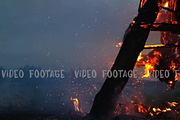 Wooden structure burns with sparks at night
