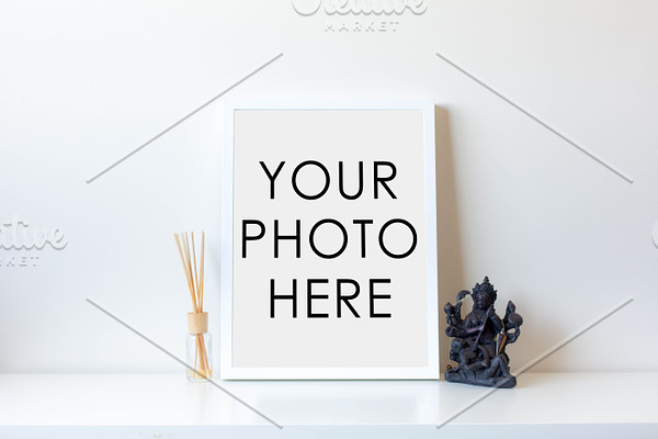 White Frame With Statue and Diffuser