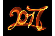Happy new year 2017 isolated numbers lettering written with fire flame or smoke on black background