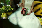 bridal bouquet in hands of bride in white wedding dress