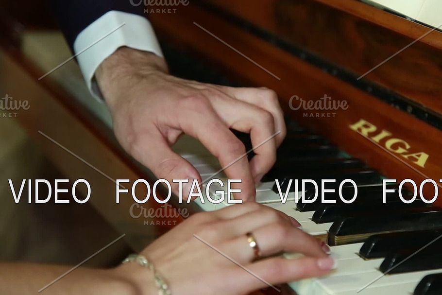 Bride and groom playing the piano together