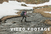 Young girl walks through the mountain river. Norway