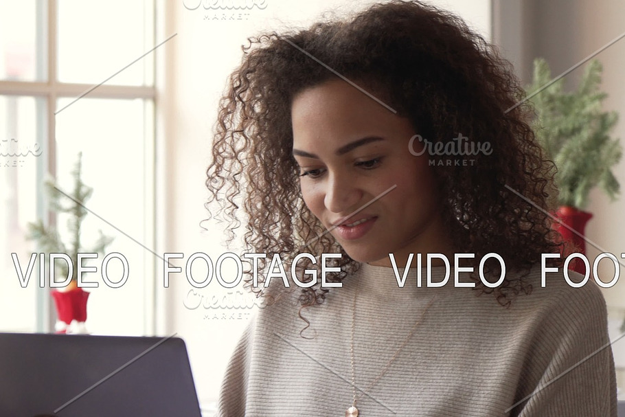 smiling african american young woman work using laptop