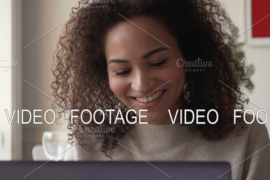 smiling african american young woman work using laptop