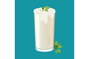 Glass of ayran with dill and parsley herbs isolated on white.