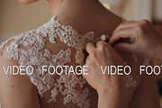 Woman hands are buttoning dress the bride's, Wedding