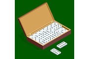 Isomeric set of dominoes in bamboo box isolated on green background