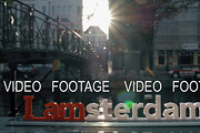 I amsterdam slogan and city view with canal