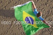 Aerial view of woman with Brazilian flag and nature scene