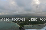 Flying over Mauritius Island with low clouds