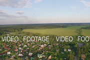 Aerial shot of village, highway and green nature in Russia