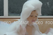 Child having fun with foam in the bath