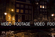 Timelapse view of cityscape during river cruise at night, Amsterdam, Netherlands