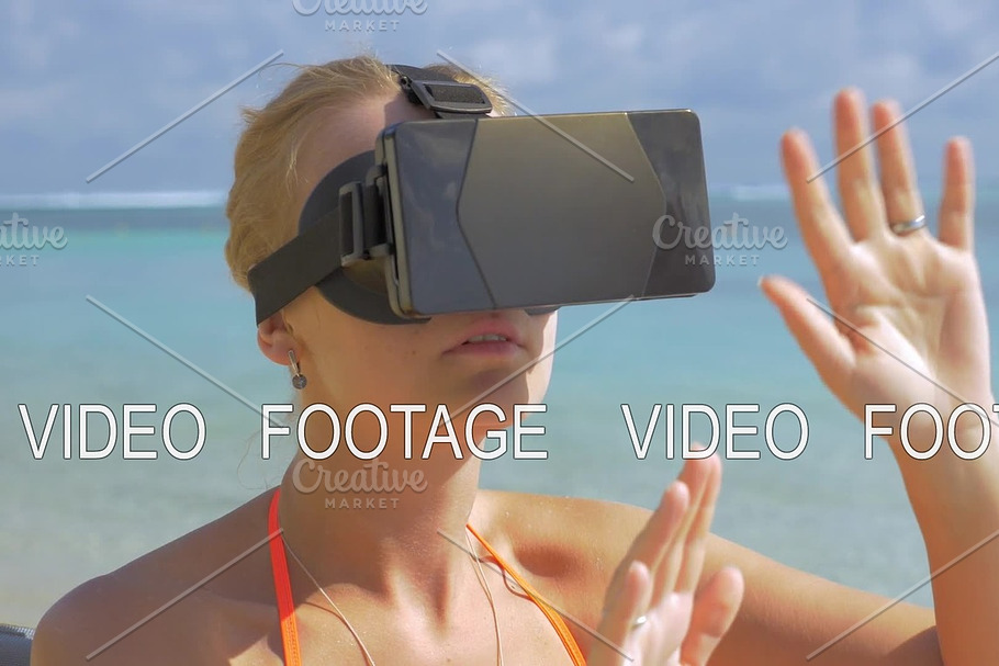 Woman using VR-headset on the beach