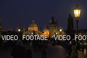 Evening cityscape with walking people on the picturesque Charles Bridge, Prague, Czech Republic