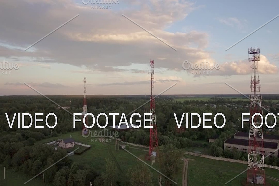 View of forest, country houses and base stations against blue sky with clouds in daylight at summer, Russia