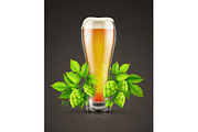 Glass of lager beer with hop plants