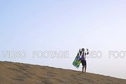 Happy boy with flag of Brazil on the beach