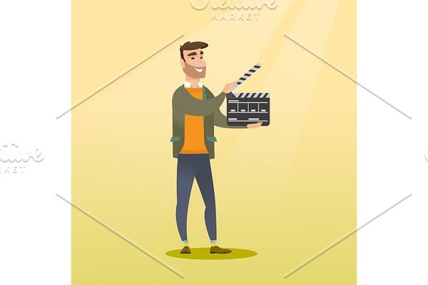 Smiling man holding an open clapperboard.