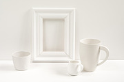 White cups and a white frame