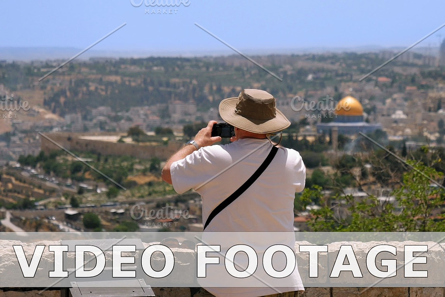 Tourist takes a photo of Jerusalem Old City view in Graphics - product preview 8