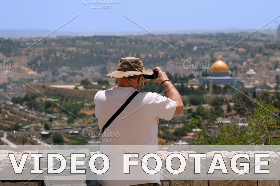 Tourist takes a photo of Jerusalem Old City view in Graphics - product preview 8