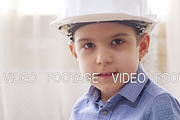 kid boy imitates engineer constructing a building using colorful meccano dreaming about profession