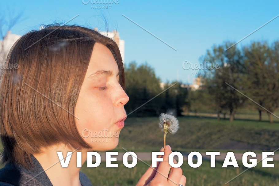 Young girl blows off the dandelion - slowmo 180 fps