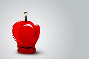 Businessman standing on boxing glove