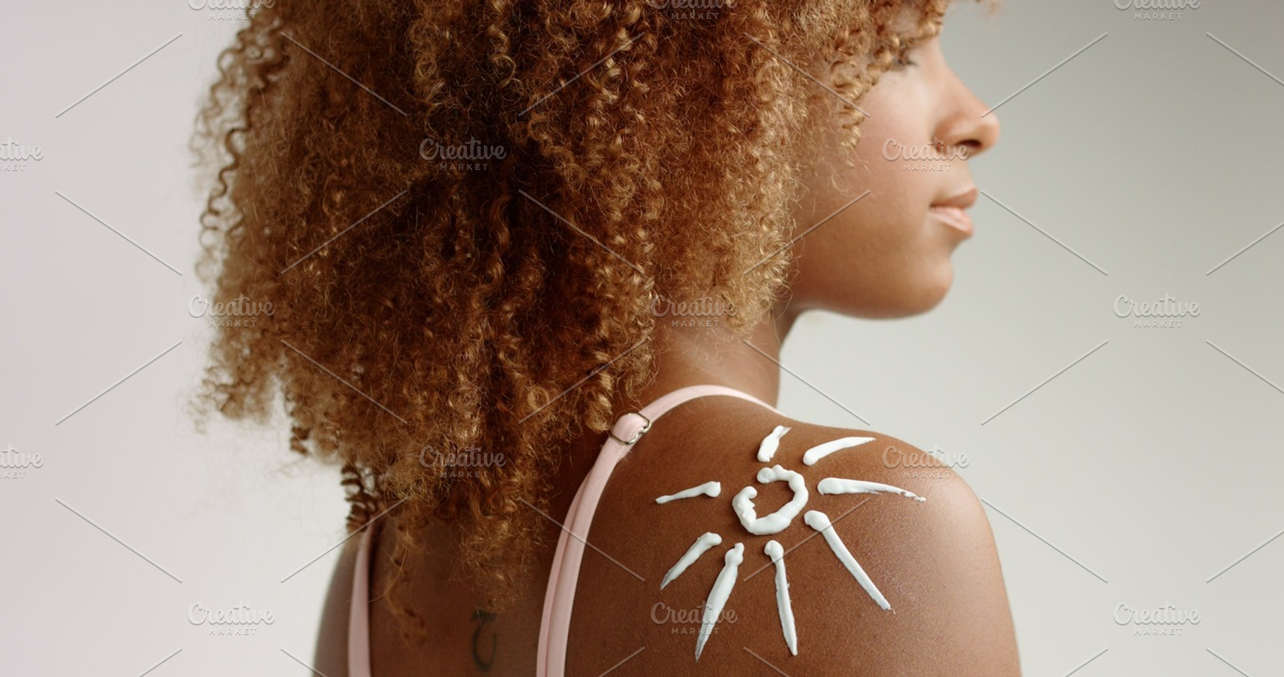 Mixed Race Black Woman With Blonde Curly Hair In Studio With Cream