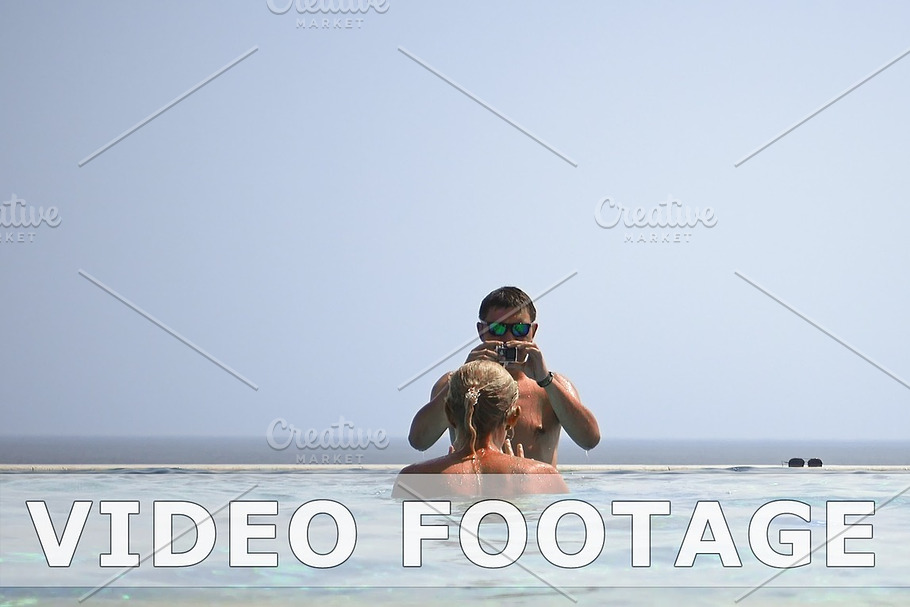 Man and woman shooting a video in a swimming pool