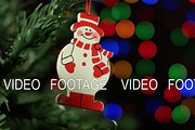 Christmas background with Christmas tree and snowman on background of blurred lights