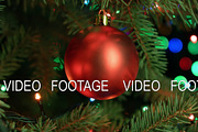 Christmas tree ball on background of blurred fairy lights garland