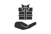 Open hand with gift box glyph icon